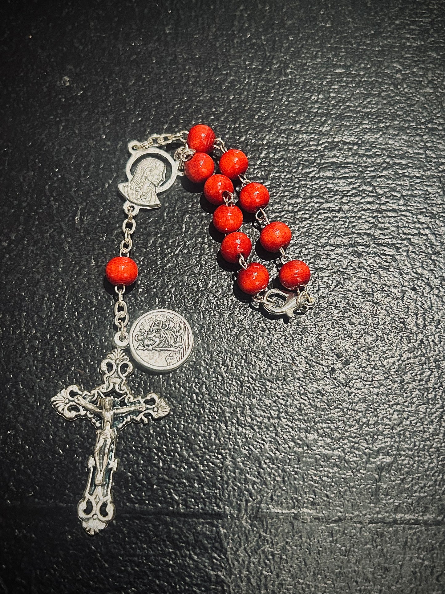 Small rosary- red beads.